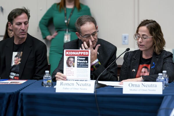 From left, Ruby Chen, father of kidnapped Israeli soldier Itay Chen, Ronen Neutra, father of Omer Neutra, and Orna Neutra, mother of Omer Neutra, join families of hostages and victims of the Hamas attacks as they meet with the House Foreign Affairs Committee, at the Capitol in Washington, Wednesday, Nov. 29, 2023. (AP Photo/J. Scott Applewhite)