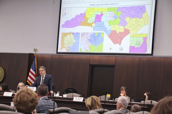 The North Carolina Senate reviews copies of a map proposal for the state's congressional districts starting in 2024 during a committee hearing at the Legislative Office Building, Oct. 19, 2023, in Raleigh, N.C. (AP Photo/Hannah Schoenbaum, File)