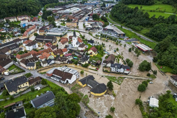 A flooded area is seen in Ravne na Koroskem, some 60 km (38 miles) northeast of Ljubljana, Slovenia, Friday, Aug. 4, 2023. Heavy rains caused flash floods and landslides in parts of Slovenia, blocking roads and bridges, flooding buildings and forcing evacuations on Friday. Slovenia's environmental agency, ARSO, raised the weather alert to the highest level after a month's amount of rain fell within 24 hours in northern, northwestern and central parts of the country. (AP Photo/Gregor Ravnjak)