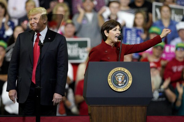 
              President Donald Trump reacts to words spoken by Iowa Gov. Kim Reynolds, during a Make America Great Again rally at the Mid-America Center in Council Bluffs, Iowa, Tuesday, Oct. 9, 2018. (AP Photo/Nati Harnik)
            
