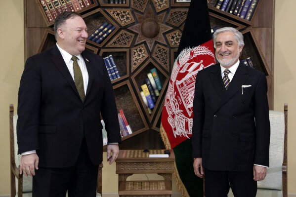 U.S. Secretary of State Mike Pompeo, left, stands with Abdullah Abdullah the main political rival of President Ashraf Ghani at the Sepidar Palace, in Kabul, Afghanistan, Monday, March 23, 2020. Pompeo was in Kabul on an urgent visit Monday to try to move forward a U.S. peace deal signed last month with the Taliban, a trip that comes despite the coronavirus pandemic, at a time when world leaders and statesmen are curtailing official travel. (Sepidar palace via AP)