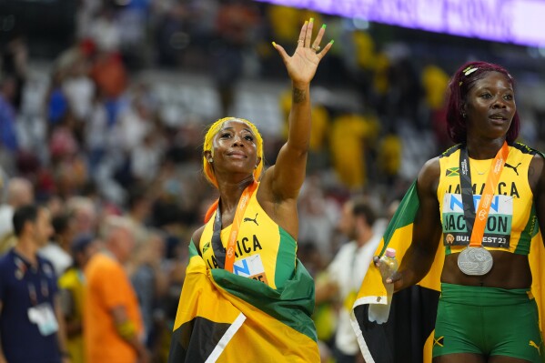 Shelly-Ann Fraser-Pryce, of Jamaica, left, and Shericka Jackson, of Jamaica react after the final of the Women's 100-meters during the World Athletics Championships in Budapest, Hungary, Monday, Aug. 21, 2023. (AP Photo/Petr David Josek)