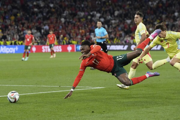 Portugal's Rafael Leao, left, is fouled by Spain's Robin Le Normand during the Nations League final soccer match between Portugal and Spain at the Allianz Arena in Munich, Germany, Sunday, June 8, 2025. (AP Photo/Martin Meissner)
