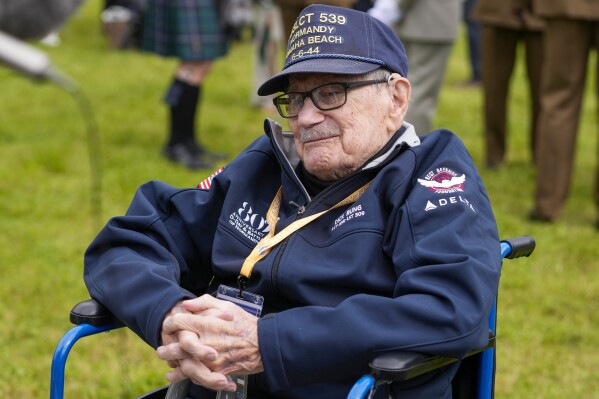 American World War II veteran Dick Rung poses during a service at the Pegasus Bridge memorial in Benouville, Normandy, France, Wednesday, June 5, 2024. World War II veterans from across the United States as well as Britain and Canada are in Normandy this week to mark 80 years since the D-Day landings that helped lead to Hitler's defeat. (AP Photo/Virginia Mayo)