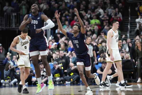 Fairleigh Dickinson guard Joe Munden Jr. (1) and Sean Moore (11) celebrate beating Purdue 63-58 after a first-round college basketball game in the NCAA Tournament Friday, March 17, 2023, in Columbus, Ohio. (AP Photo/Paul Sancya)