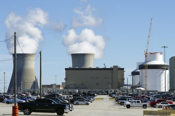 FILE - Reactors for Unit 3 and 4 sit at Georgia Power's Plant Vogtle nuclear power plant on Jan. 20, 2023, in Waynesboro, Ga., with the cooling towers of older Units 1 and 2 billowing steam in the background. Company officials announced Wednesday, May 24, 2023, that Unit 3 would reach full power in coming days, after years of delays and billions in cost overruns. (AP Photo/John Bazemore)