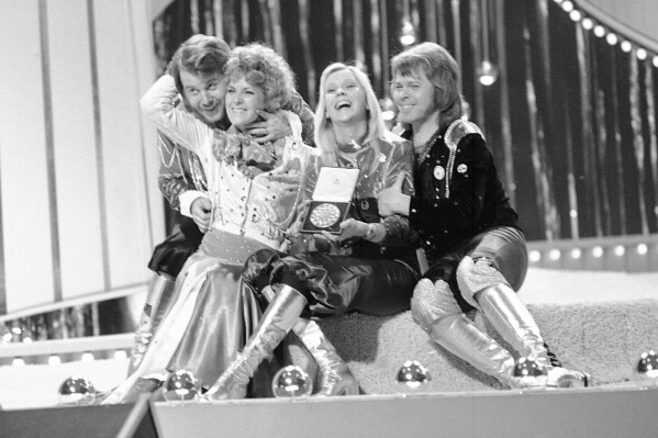 FILE - Swedish pop group ABBA celebrate winning the 1974 Eurovision Song Contest on stage at the Brighton Dome in England with their song Waterloo, April 6, 1974. The 68th Eurovision Song Contest is taking place in May in Malmö, Sweden. It will see acts from 37 countries vie for the continent’s pop crown. Founded in 1956, Eurovision is a feelgood extravaganza that strives to banish international strife and division. It’s known for songs that range from anthemic to extremely silly, often with elaborate costumes and spectacular staging. (AP Photo/Robert Dear, File)