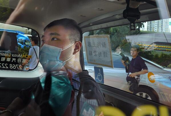 FILE - In this July 6, 2020, file photo, Tong Ying-kit arrives at a court in a police van in Hong Kong. Hong Kong High Court will deliver verdict Tuesday afternoon, July 27, 2021 for the first person charged under Hong Kong's National Security Law. Tong was arrested in July 2020 after driving his motorbike into a group of police officers while carrying a flag bearing the protest slogan “Liberate Hong Kong." He was charged with inciting separatism and terrorism. (AP Photo/Vincent Yu,File)