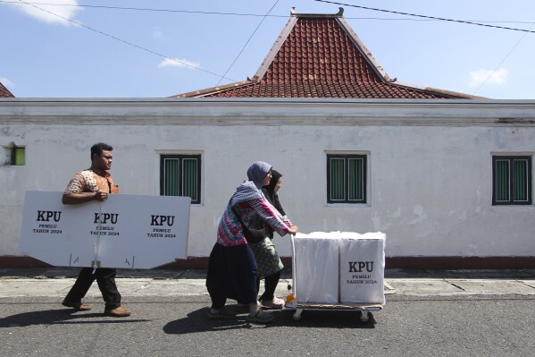 People use a cart to transport ballot boxes ahead of the Feb. 14 election in Yogyakarta, Indonesia, Tuesday, Feb. 13, 2024. Indonesia, the world's third-largest democracy, will open its polls on Wednesday to nearly 205 million eligible voters in presidential and legislative elections, the fifth since Southeast Asia's largest economy began democratic reforms in 1998. (AP Photo/Slamet Riyadi)