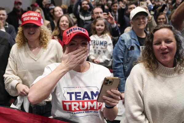 Supporters react as former President Donald Trump arrives to speak at a rally at Simpson College in Indianola, Iowa, Sunday, Jan. 14, 2024. (AP Photo/Andrew Harnik)
