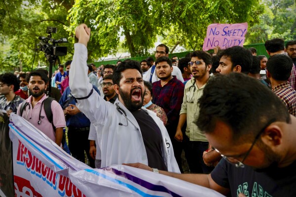 Doctors and paramedics protesting against the rape and killing of a trainee doctor at a government hospital in Kolkata gather in front of the Indian health minister's office, in New Delhi, India, Monday, Aug. 19, 2024. (AP Photo/Manish Swarup)