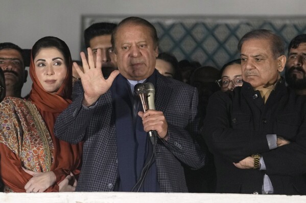 Pakistan's Former Prime Minister Nawaz Sharif, center, addresses supporters next to his brother Shehbaz Sharif, right, and daughter Maryam Nawaz following initial results of the country's parliamentary election, in Lahore, Pakistan, Friday, Feb. 9, 2024. Sharif is changing tack and said on Friday that he will seek to form a coalition government after his party trailed the independent candidates of his rival Imran Khan in preliminary results following the country’s parliamentary election. (AP Photo/K.M. Chaudary)