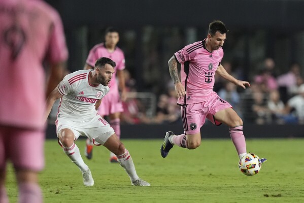 Inter Miami forward Lionel Messi (10) controls the ball next to St. Louis City midfielder Eduard Loewen during the first half of an MLS soccer match Saturday, June 1, 2024, in Fort Lauderdale, Fla. (AP Photo/Rebecca Blackwell)