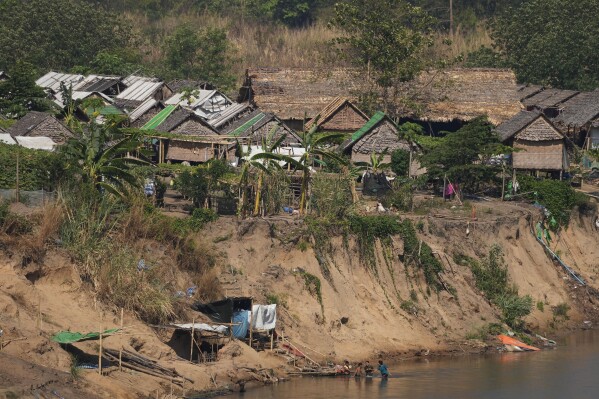 File - A camp for internally displaced people in Myanmar is seen across the Moei river from Mae Sot, Tak province Thailand, Monday, March 25, 2024. Guerrilla fighters belonging to Myanmar's Karen ethnic minority claimed Monday to be close to seizing control of a major trading town bordering Thailand, as soldiers and civil servants loyal to the military government appeared to be preparing to abandon their positions. (AP Photo/Sakchai Lalit, File)