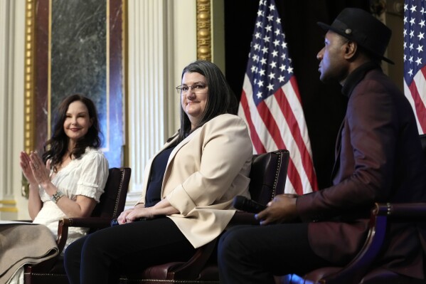 CORRECTS NAME TO SUICIDE PREVENTION RESOURCE CENTER Shelby Rowe, center, Executive Director of the Suicide Prevention Resource Center, flanked by Ashley Judd, left, and singer-songwriter Aloe Blacc, right, finishes speaking during an event on the White House complex in Washington, Tuesday, April 23, 2024, with notable suicide prevention advocates. The White House held the event on the day they released the 2024 National Strategy for Suicide Prevention to highlight efforts to tackle the mental health crisis and beat the overdose crisis. (AP Photo/Susan Walsh)