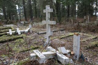 Orthodox crosses lay broken on the ground at the Russian Cemetery in Sitka, Alaska, Tuesday, Jan. 18, 2022. About 20 headstones were knocked over or damaged in the cemetery, and Sitka police are investigating. (James Poulson/The Daily Sitka Sentinel via AP)