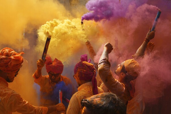 FILE - People sing, dance and throw colors at each other to celebrate Holi festival in Hyderabad, India, Monday, March 6, 2023. (AP Photo/Mahesh Kumar A., File)