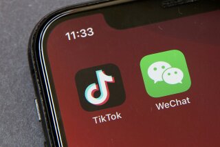 FILE - A federal judge has approved a request from a group of WeChat users to delay looming U.S. government restrictions that could effectively make the popular app nearly impossible to use. In a ruling dated Saturday, Sept. 19, 2020, Magistrate Judge Laurel Beeler in California said the government’s actions would affect users’ First Amendment rights as an effective ban on the app removes their platform for communication. (AP Photo/Mark Schiefelbein, File)