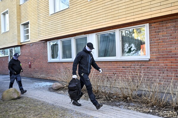 Police on site after an explosion in Tyreso, Sweden, Thursday March 7, 2023. Sweden’s Security Service said Thursday it had arrested four people on suspicion of preparing “terrorist offenses” with links to Islamic extremism and organized crime. Several houses were searched in the operation. (Anders Wiklund/TT via AP)