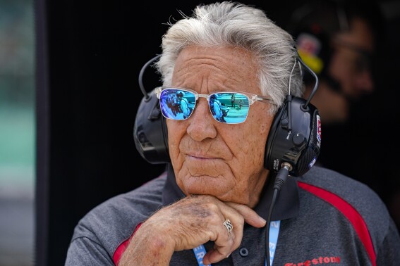 FILE - 1969 Indy 500 champion Mario Andretti watches from his grandson Marco Andretti's pit area during practice for the Indianapolis 500 auto race at Indianapolis Motor Speedway in Indianapolis, May 19, 2023. Mario said Friday, April 19, 2024, he was "offended" by the reasons given by Formula One for denying his family the chance to join the global motorsports series. (AP Photo/Michael Conroy, File)