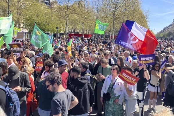 People gather during a leftist demonstration at Place de la République, denouncing what organizers called a "Trumpist turn" by Le Pen's National Rally (RN) party, while supporters of French far-right leader Marine Le Pen were gathering to protest her conviction for embezzlement and a five-year ban on running for office, Sunday, April 6, 2025 in Paris. (AP Photo/Jeffrey Schaeffer)