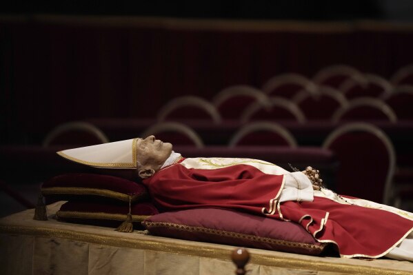 The body of late Pope Emeritus Benedict XVI laid out in state inside St. Peter's Basilica at The Vatican, Jan. 2, 2023. (AP Photo/Andrew Medichini)