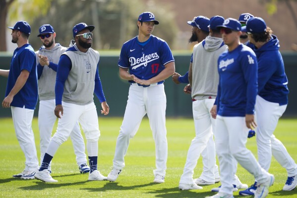 Los Angeles Dodgers designated hitter Shohei Ohtani (17) participates in spring training baseball workouts at Camelback Ranch in Phoenix, Sunday, Feb. 18, 2024. (AP Photo/Ashley Landis)