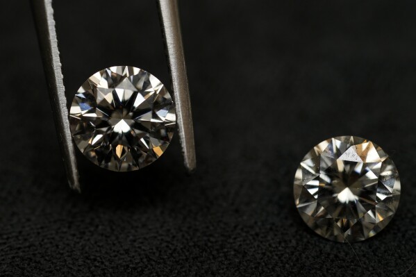 A lab grown diamond, left, and a natural diamond are displayed at Bario Neal, a jewelry store, in Philadelphia, Wednesday, Feb. 7, 2024. Diamonds, whether lab-grown or natural, are chemically identical and entirely made out of carbon. (AP Photo/Matt Rourke)