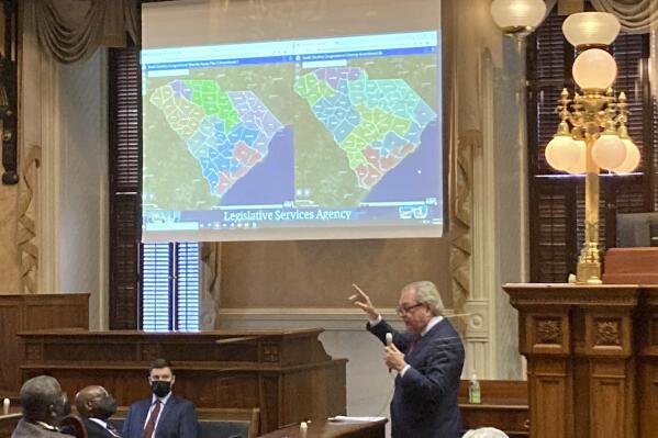 State Sen. Dick Harpootlian, D-Columbia, compares his proposed map of U.S. House districts drawn with 2020 U.S. Census data to a plan supported by Republicans on Thursday, Jan. 20, 2022, in Columbia, S.C.. The full Senate was debating the maps. (AP Photo/Jeffrey Collins)