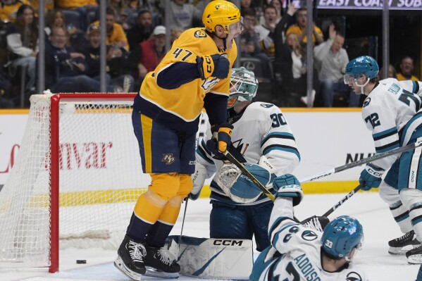 Nashville Predators right wing Michael McCarron (47) celebrates his goal in front of San Jose Sharks goaltender Magnus Chrona (30) during the second period of an NHL hockey game Tuesday, March 19, 2024, in Nashville, Tenn. (AP Photo/George Walker IV)