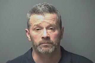 This booking photo released Tuesday, March 24, 2020, by the Manchester, N.H., Police Department shows Benjamin Layland, accused of grabbing a sword and chasing after another man who asked him to turn down his music. (Manchester Police Department via AP)