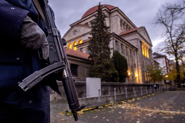 FILE -A German police officer stands guard in front of the synagogue in Frankfurt, Germany, early Wednesday, Nov. 8, 2023. A group tracking antisemitism in Germany said Tuesday that it documented a drastic increase of antisemitic incidents in the country in the month after Hamas attacked Israel on Oct. 7. The RIAS group said, it recorded 994 incidents, which is an average of 29 incidents per day and an increase of 320% compared to the same time period in 2022. The group looked at the time period from Oct. 7 to Nov. 9, 2023. (AP Photo/Michael Probst, File)