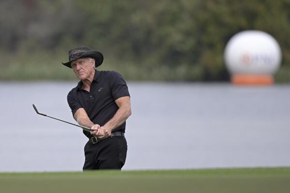 FILE - Greg Norman, of Australia, watches after hitting from a bunker onto the 18th green during the final round of the PNC Championship golf tournament Dec. 20, 2020, in Orlando, Fla. Norman says Trump National Doral Miami will host the final event of his Saudi-backed golf series. (AP Photo/Phelan M. Ebenhack, File)