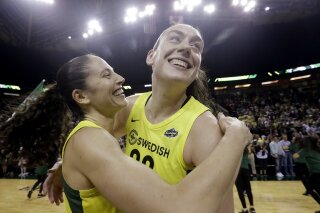 FILE - This Sept. 4, 2018, file photo shows Seattle Storm's Sue Bird, left, and Breanna Stewart embracing after the Storm defeated the Phoenix Mercury 94-84 during Game 5 of a WNBA basketball playoff semifinal, in Seattle. With Breanna Stewart and Sue Bird back, the Seattle Storm are healthy to begin the season and sit atop the preseason Associated Press WNBA poll. The Storm were the unanimous choice receiving all 16 first-place votes from the national media panel Tuesday, July 21, 2020. (AP Photo/Elaine Thompson, File)
