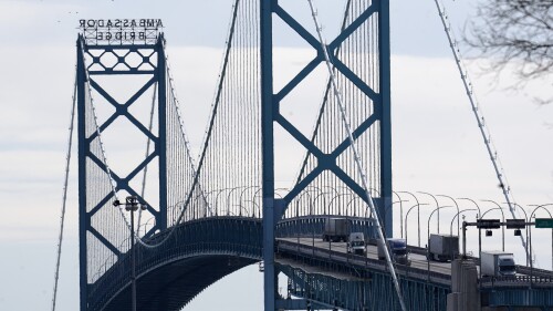 FILE - Traffic flows over the Ambassador Bridge in Detroit, Feb. 14, 2022. A man survived after plunging 150 feet (45.7 meters) into the Detroit River from Ambassador Bridge, a bridge connecting Michigan and Canada. The man, identified as a contractor who was working on the Ambassador Bridge, was rescued Wednesday, July 12, 2023, by a crew aboard a Detroit boat that delivers mail and packages. (AP Photo/Paul Sancya, File)