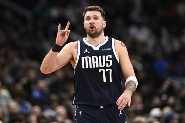 Dallas Mavericks guard Luka Doncic (77) gestures during the second half of an NBA basketball game against the Washington Wizards, Thursday, Dec. 5, 2024, in Washington. The Mavericks won 137-101. (AP Photo/Nick Wass)