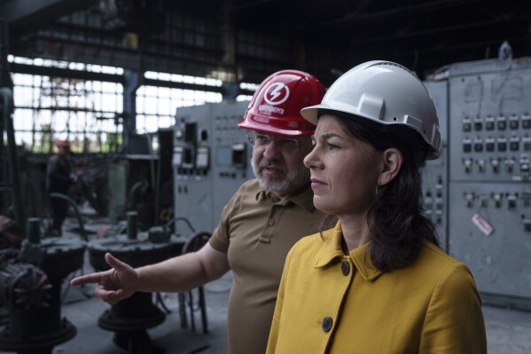 German's Foreign Minister Annalena Baerbock speaks to Ukrainian Energy Minister Herman Halushchenko during official visit to a thermal power plant which was destroyed by a Russian rocket attack in Ukraine, Tuesday, May 21, 2024. (AP Photo/Evgeniy Maloletka)