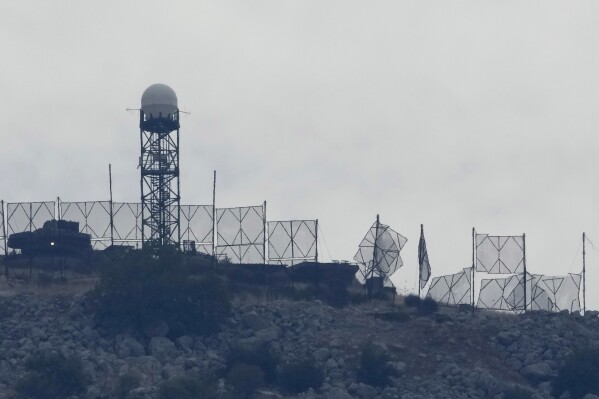 The fence of an Israeli military position is seen damaged after Hezbollah targeted it by rockets, on an occupied hill of Kfar Chouba village, southeast Lebanon, Sunday, Oct. 8, 2023. (AP Photo/Hussein Malla, File)