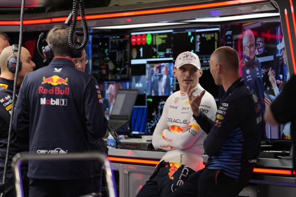 Red Bull driver Max Verstappen of the Netherlands chats with team members in the garage during the second free practice session at the Suzuka Circuit in Suzuka, central Japan, Friday, April 5, 2024, ahead of Sunday's Japanese Formula One Grand Prix. (AP Photo/Hiro Komae)