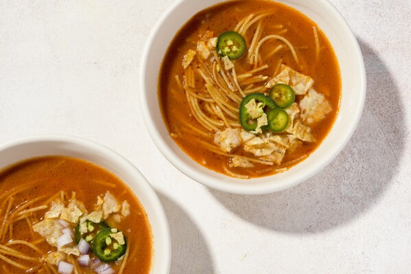 This image released by Milk Street shows a recipe for Mexican noodle soup with fire-roasted tomatoes. (Milk Street via AP)