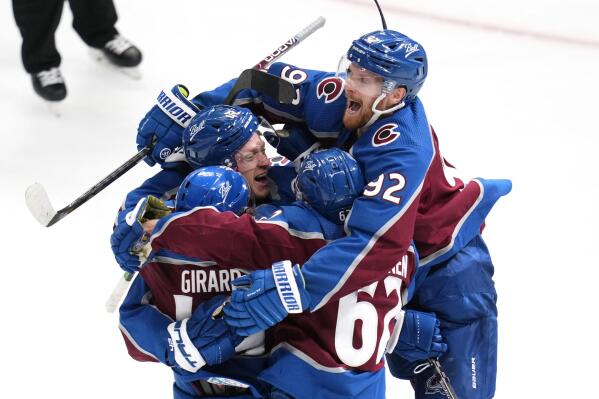 Colorado Avalanche defenseman Josh Manson (42) is congratulated by Samuel Girard (49), Artturi Lehkonen (62) and Gabriel Landeskog (92) after scoring in overtime against the St. Louis Blues in Game 1 of an NHL hockey Stanley Cup second-round playoff series Tuesday, May 17, 2022, in Denver. The Avalanche won 3-2. (AP Photo/Jack Dempsey)