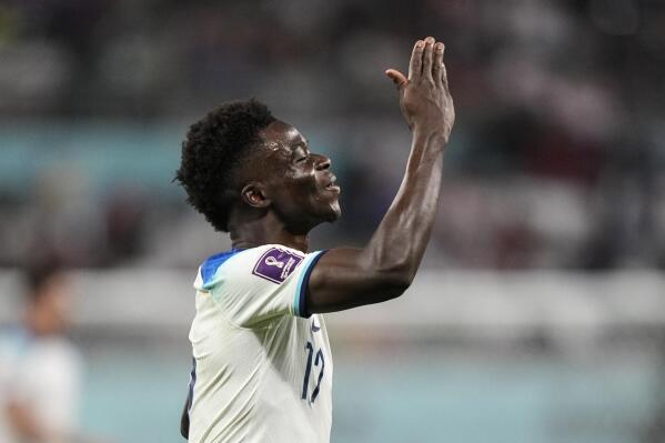 England's Bukayo Saka celebrates after scoring his side's fourth goal against Iran during the World Cup group B soccer match between England and Iran at the Khalifa International Stadium, in Doha, Qatar, Monday, Nov. 21, 2022. (AP Photo/Martin Meissner)