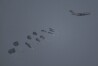 An aircraft airdrops humanitarian aid over northern Gaza Strip as seen from southern Israel, Thursday, March 28, 2024. (AP Photo/Leo Correa)