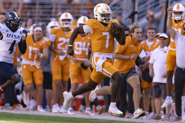 Tennessee quarterback Joe Milton III (7) outruns the UTSA defense for an 81-yard touchdown on the first play from scrimmage during an NCAA college football game Saturday, Sept. 23, 2023, in Knoxville, Tenn. (AP Photo/Wade Payne)