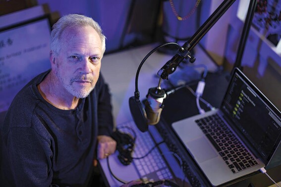 This image provided by Tulane University shows Nick Spitzer, host of the weekly public radio music and cultural program, American Routes, in his studio at Tulane University in New Orleans on Monday, Jan. 30, 2023. The show is celebrating “25 Years on the Road” in September, and Spitzer is being honored at the Library of Congress in Washington, D.C., on Sept. 29. (Rusty Costanza/Tulane University via AP)