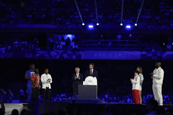 President of the Paris 2024 Organizing Committee, Tony Estanguet speaks next to IOC President Thomas Bach during the 2024 Summer Olympics closing ceremony at the Stade de France, Sunday, Aug. 11, 2024, in Saint-Denis, France. (AP Photo/Natacha Pisarenko)
