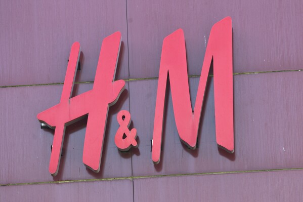 File - The logo of Swedish clothing-retail company Hennes & Mauritz (H&M) is pictured in Velizy, outside Paris, France, Wednesday, Sept. 20, 2017. A pioneering bill to curb the rampant pace of fast fashion won unanimous approval in the French Parliament, making France one of the first countries in the world to target the influx of low-cost, mass-produced garments. (AP Photo/Michel Euler)