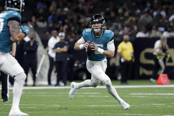 Jacksonville Jaguars quarterback Trevor Lawrence (16) scrambles in the first half of an NFL preseason football game against the New Orleans Saints in New Orleans, Monday, Aug. 23, 2021. (AP Photo/Derick Hingle)
