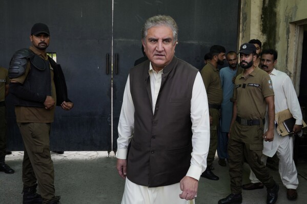 FILE - Shah Mahmood Qureshi, center, a top leader of Pakistan's former Prime Minister Imran Khan's 