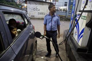 FILE - A man fills his car at a gasoline station in Gauhati, India, Sunday, Sept. 22, 2019. The state-run Indian Oil Corp. bought 3 million barrels of crude oil from Russia earlier this week to secure its energy needs, resisting Western pressure to avoid such purchases, an Indian government official said Friday, March 18, 2022. (AP Photo/Anupam Nath, File)